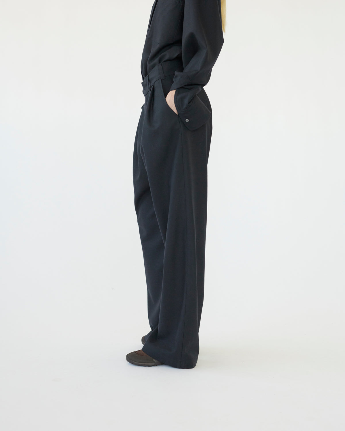 Model wearing navy pants on a white background