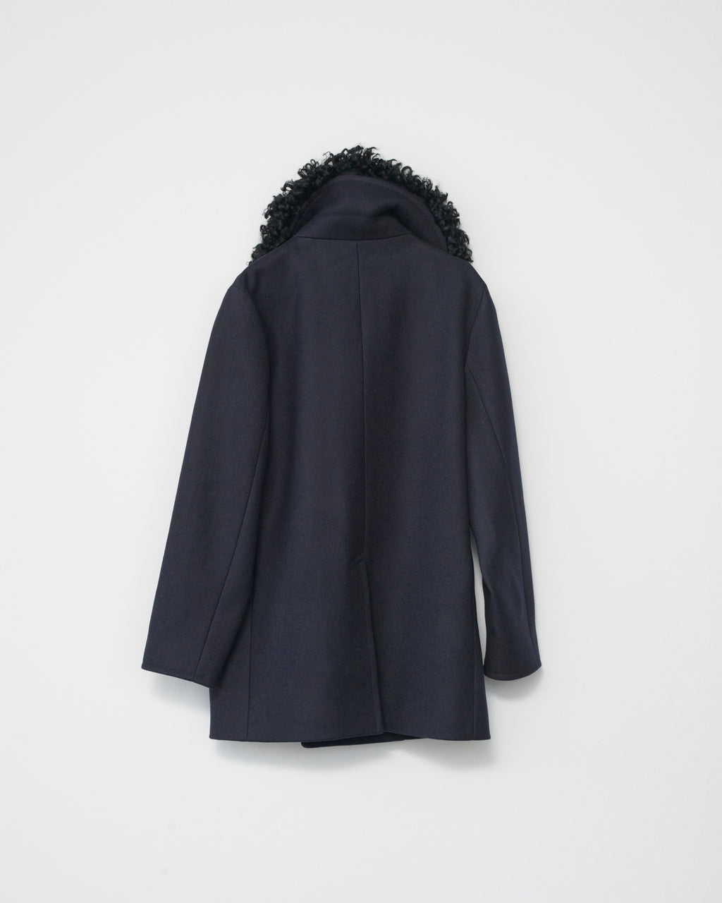 Dark blue coat with black fur hood on a white background