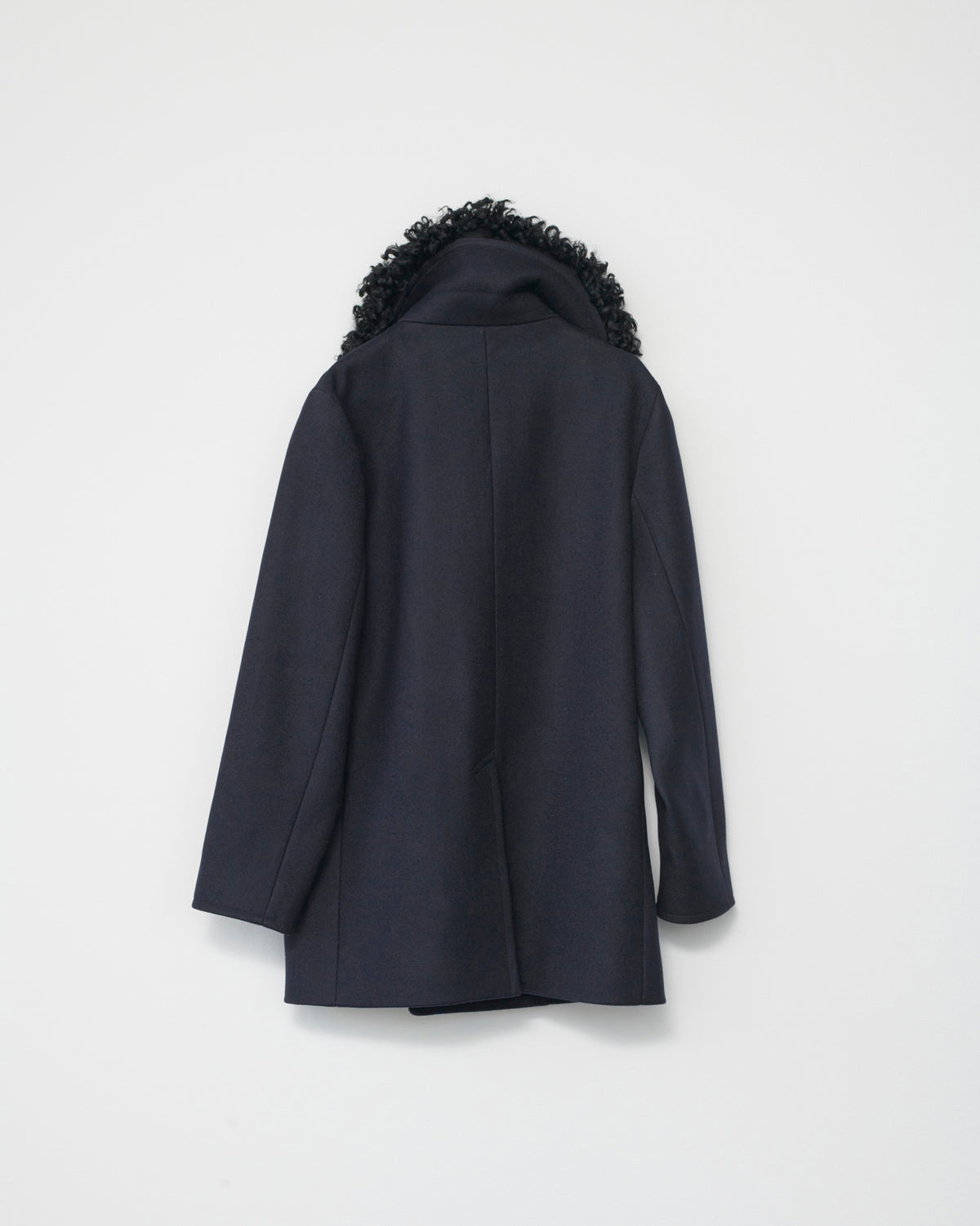 Dark blue coat with black fur hood on a white background