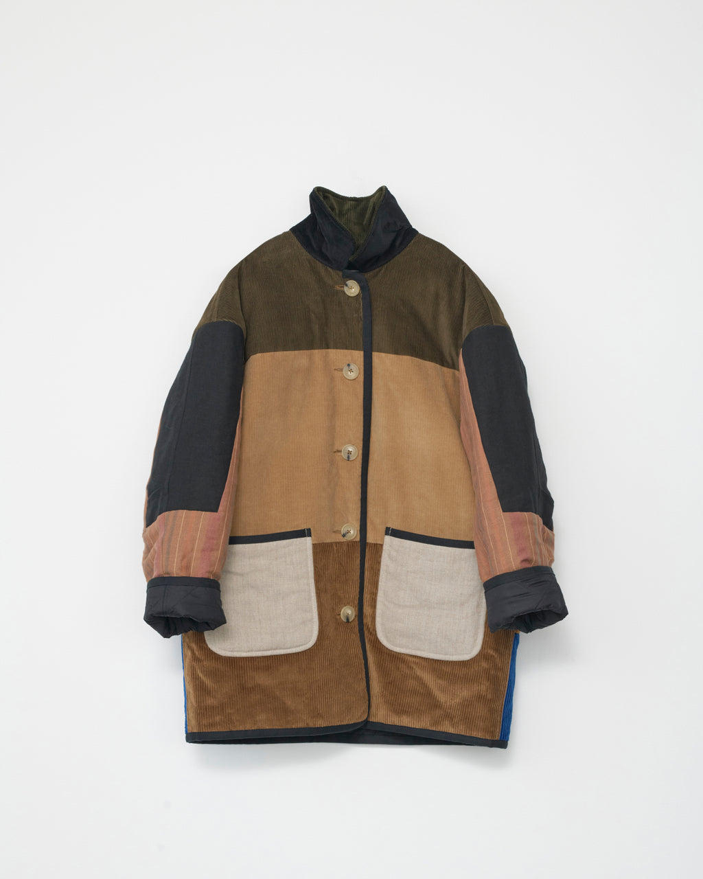 Multicolored coat with patchwork design on a white background. Front view