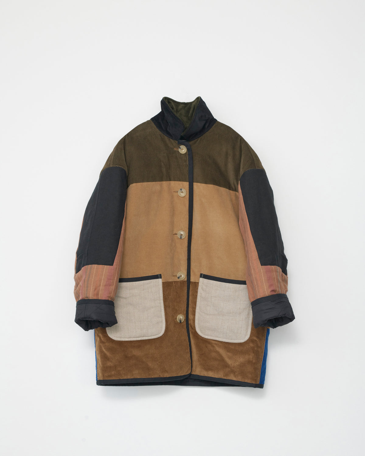 Multicolored coat with patchwork design on a white background. Front view