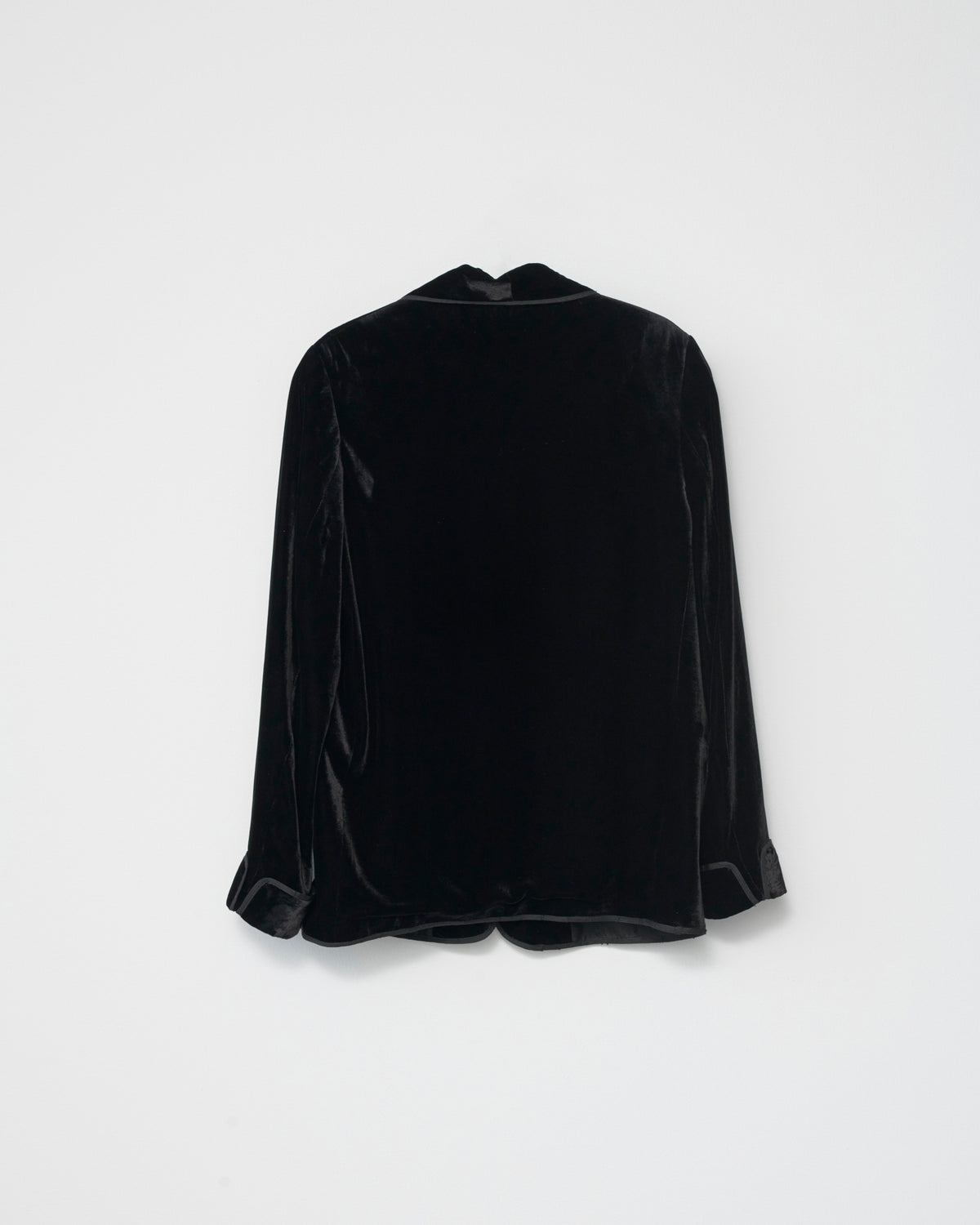 Black silk velvet blazer on a light gray background. Back view