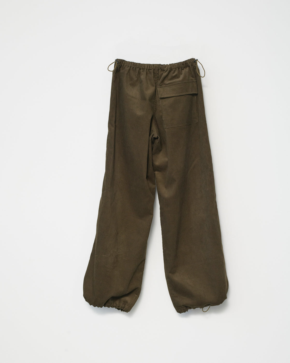 A pair of wide-leg corduroy trousers in olive with an adjustable elastic waistband. White background, front view.