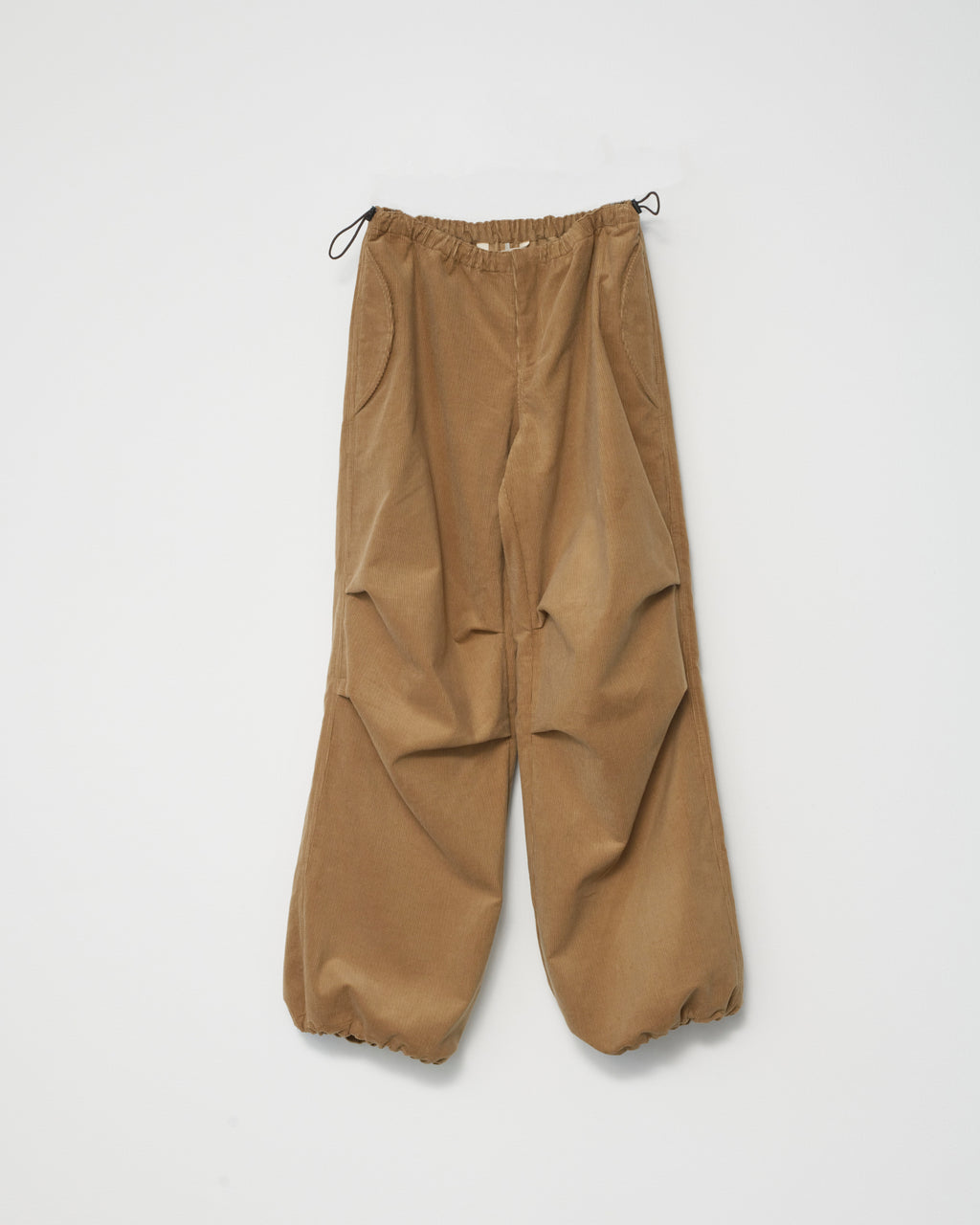 a pair of wide-leg corduroy trousers in tobacco with an adjustable elastic waistband. White background, front view.