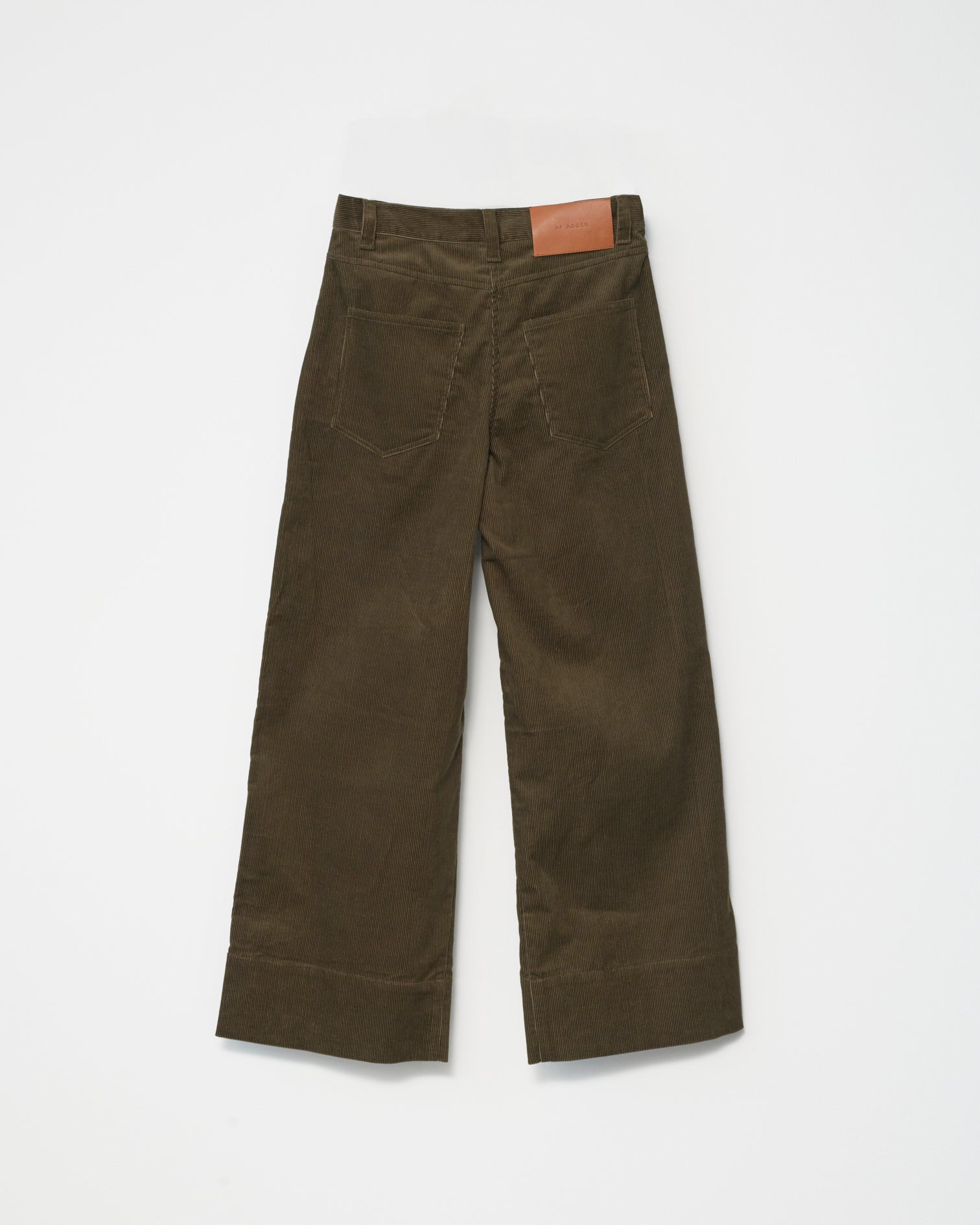 A pair of cognac-colored corduroy trousers against a white background back view.