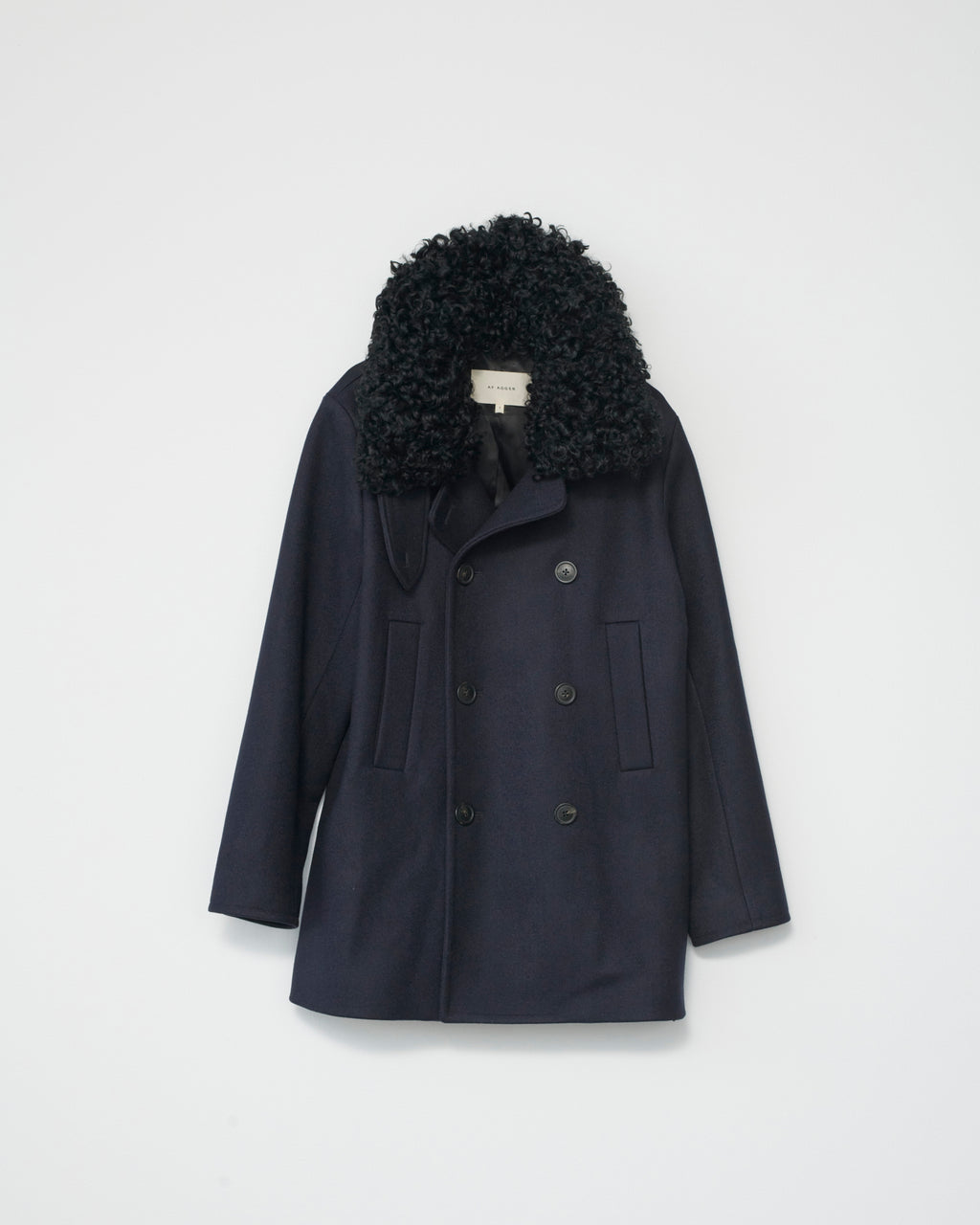 Navy jacket with black sheep fur collar on a light gray background