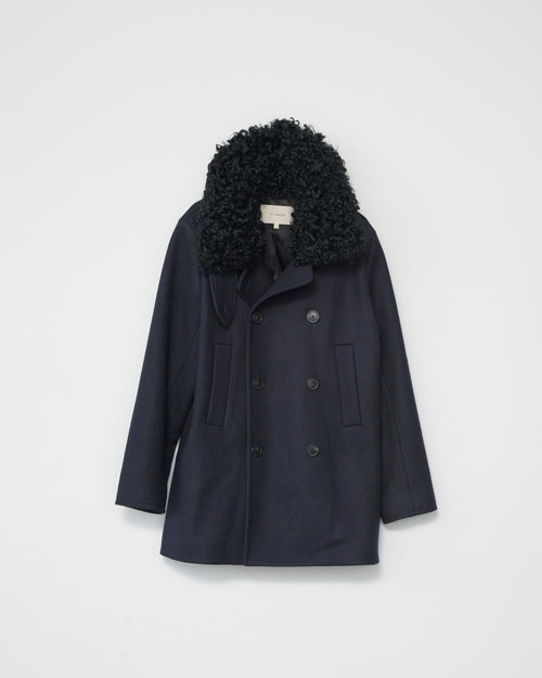 Navy jacket with black sheep fur collar on a light gray background