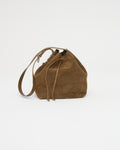 Brown suede handbag with a strap on a white background. Front view