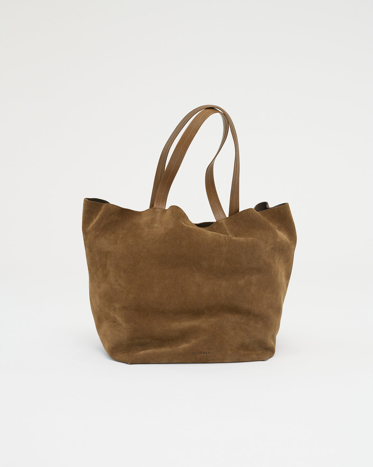 Brown suede tote bag on a white background . Front View