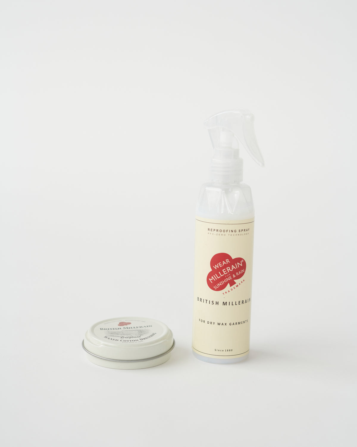 A tin container of British Millerain waxed cotton dressing with a label that includes the brand name and product details.