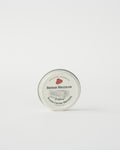 A tin container of British Millerain waxed cotton dressing with a label that includes the brand name and product details.