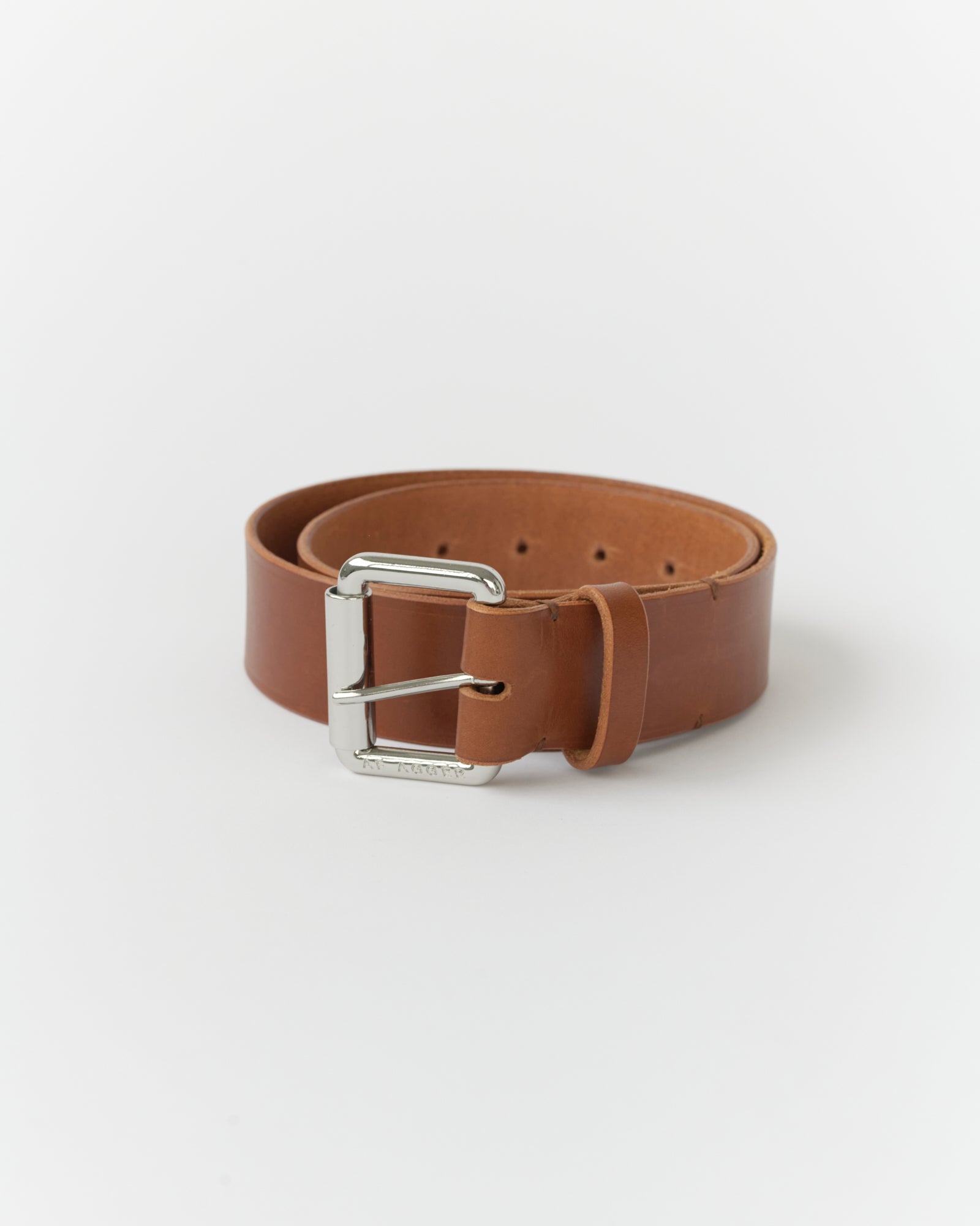 Wide cognac belt with a silver buckle on a white background