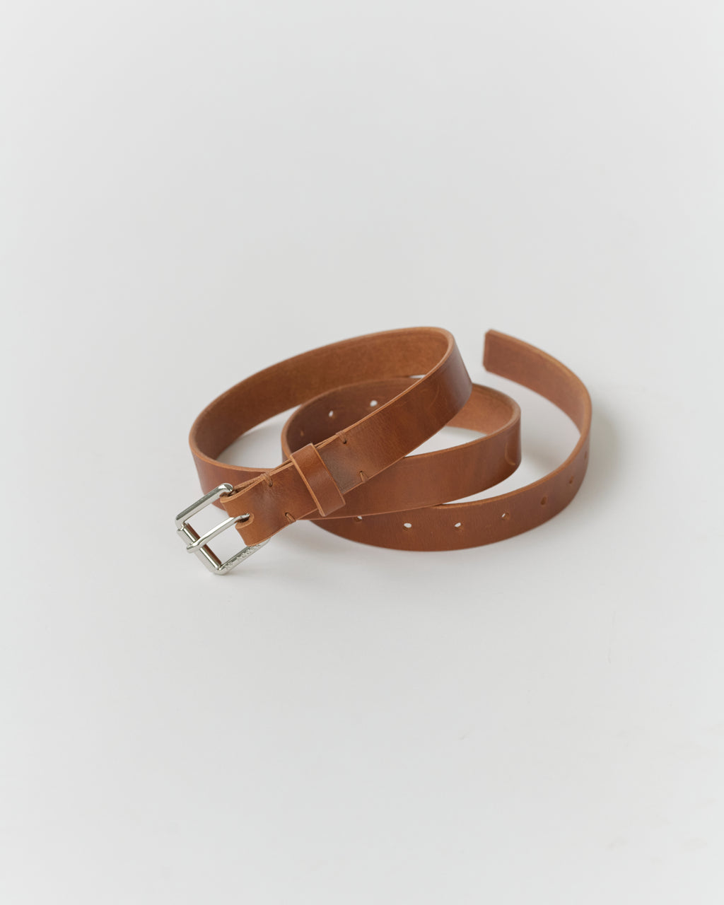 A narrow brown leather belt with a metal buckle, displayed on a white background.